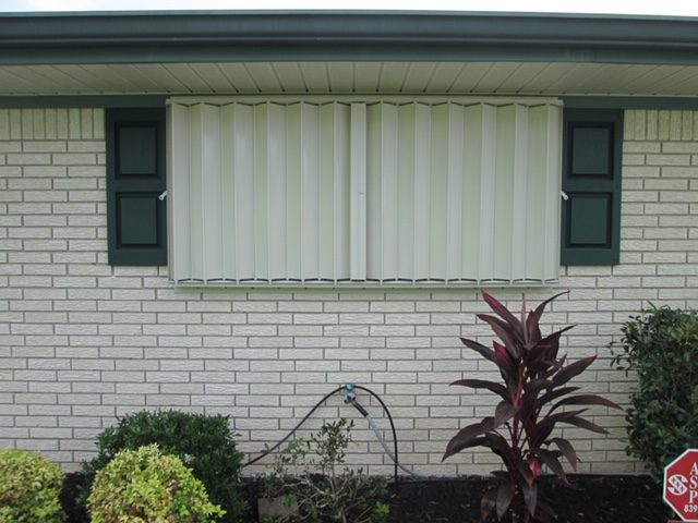 accordian style shutters closed to protect home from storms