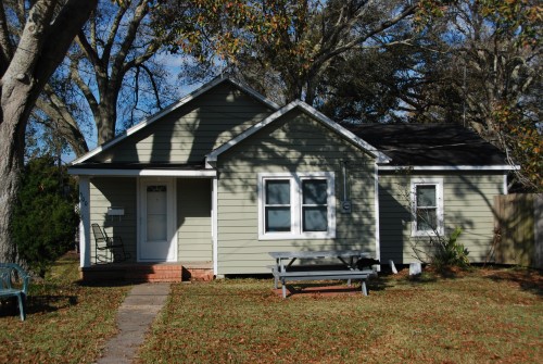 after vinyl siding transformation to green with white trim