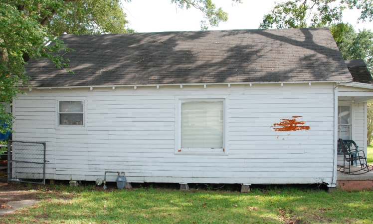 before - white run down house